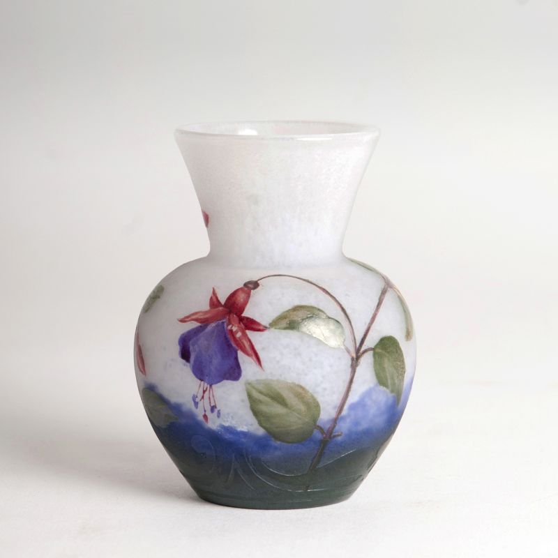 A miniature vase with colorful fuchsias