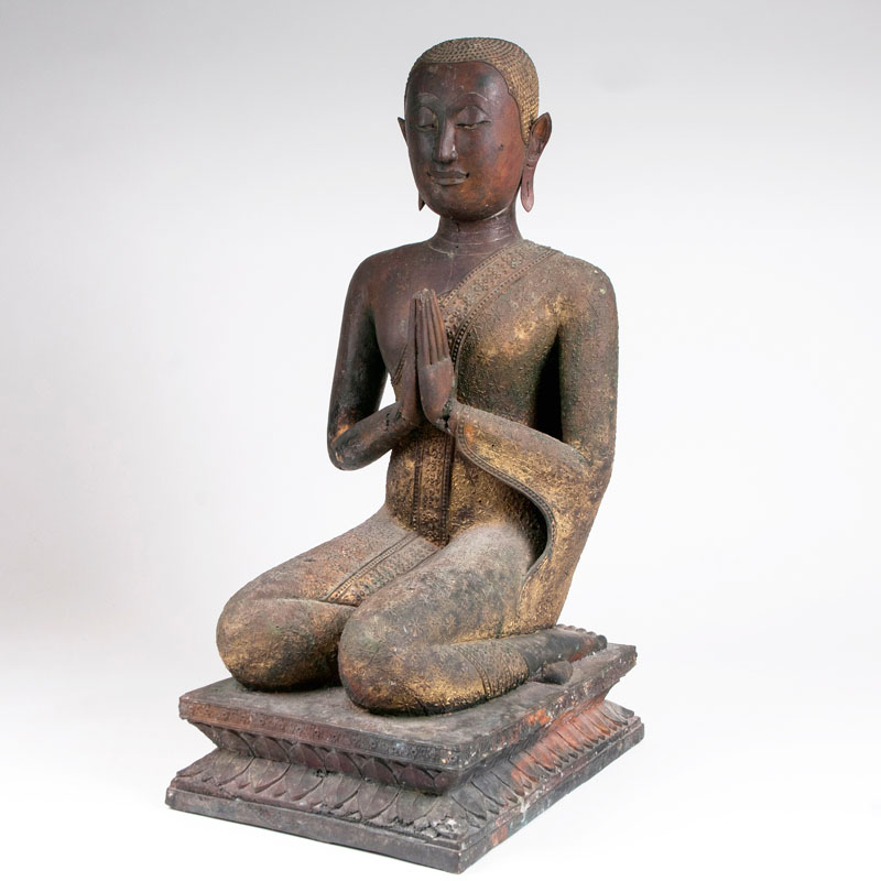 A bronze sculpture 'Kneeling Buddha's disciple'