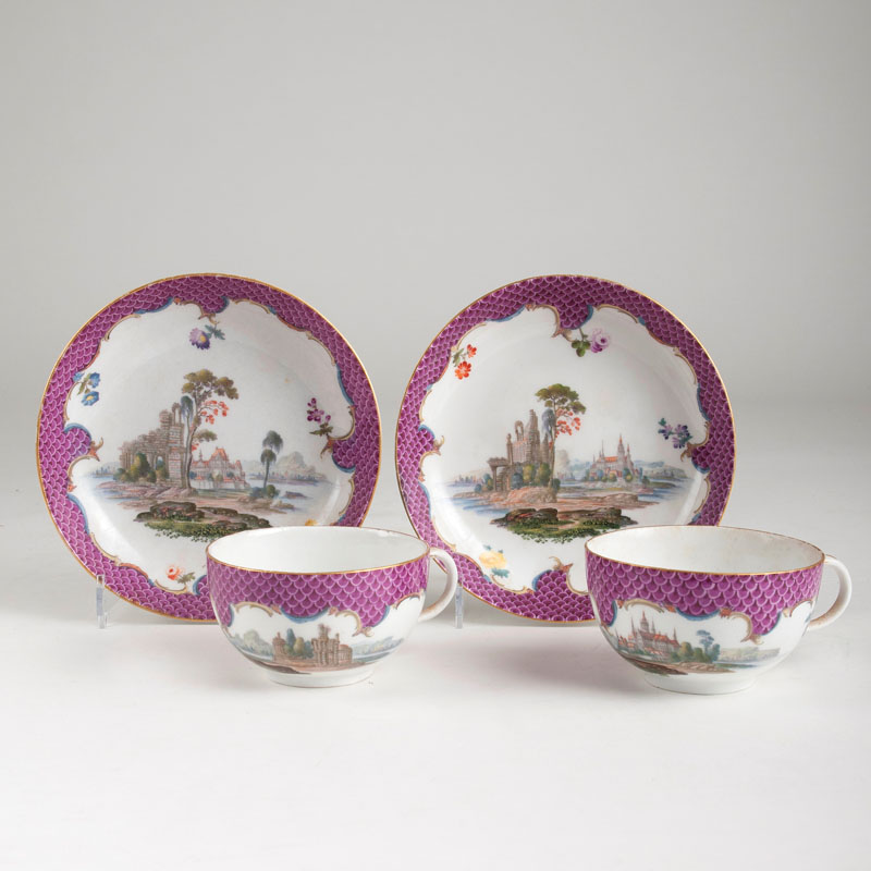 A pair of cups with landscapes and purple scales