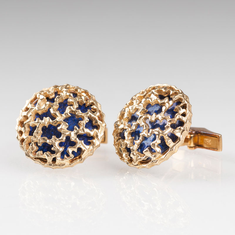 A pair of cufflinks with enamel and gold ornaments