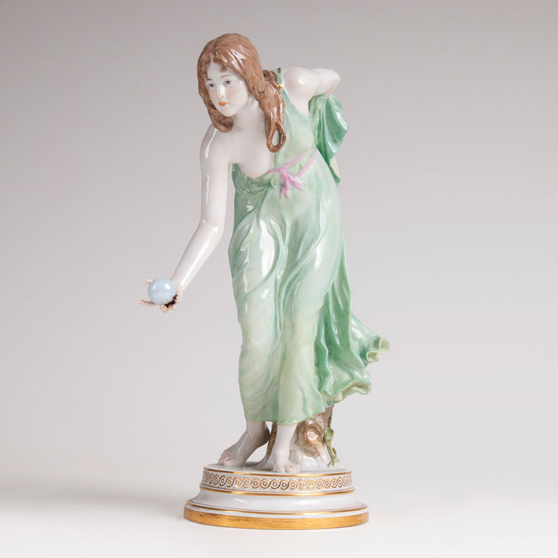 A porcelain figure 'A ball playing young lady'