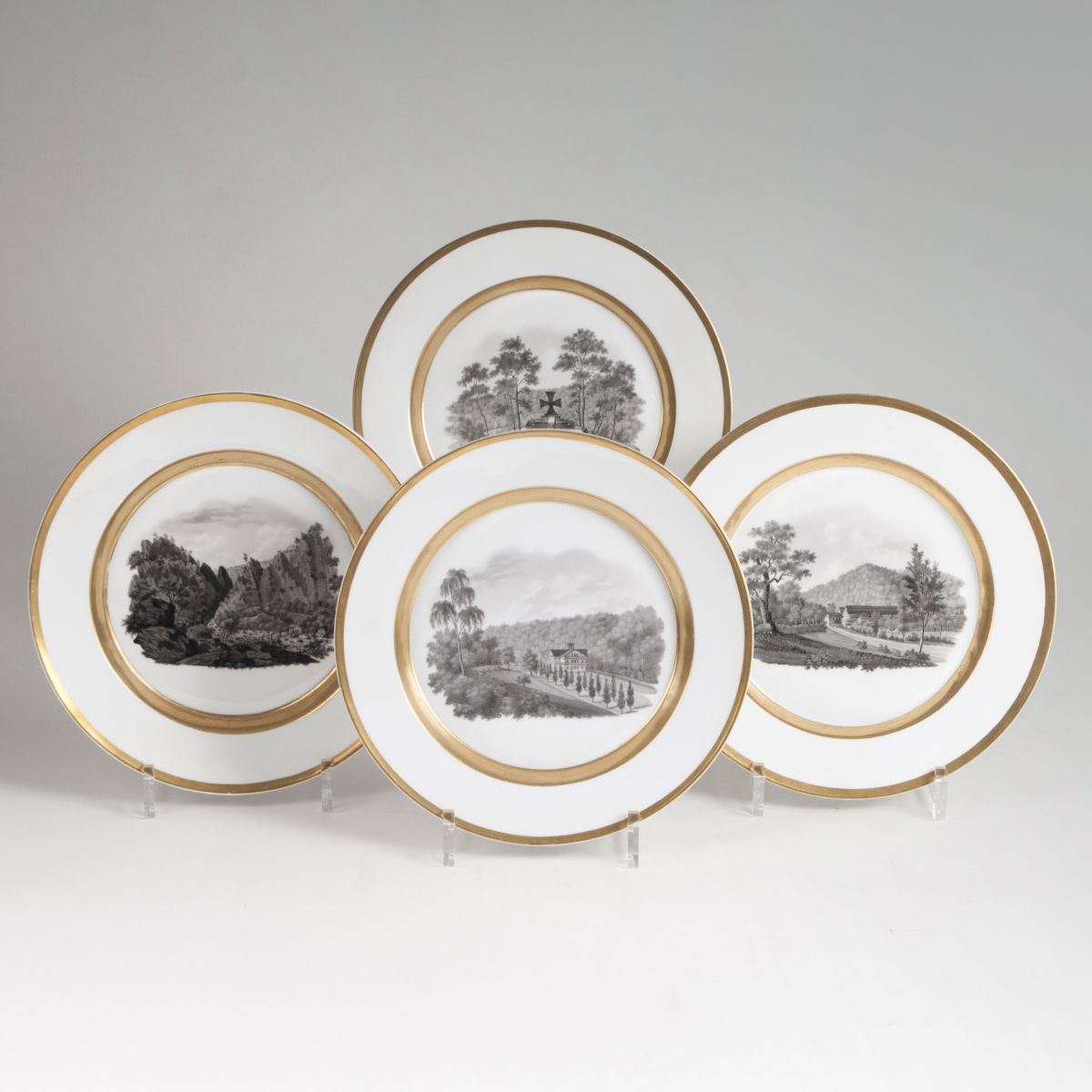 A set of 4 plates with landscape scenes in grisaille technique