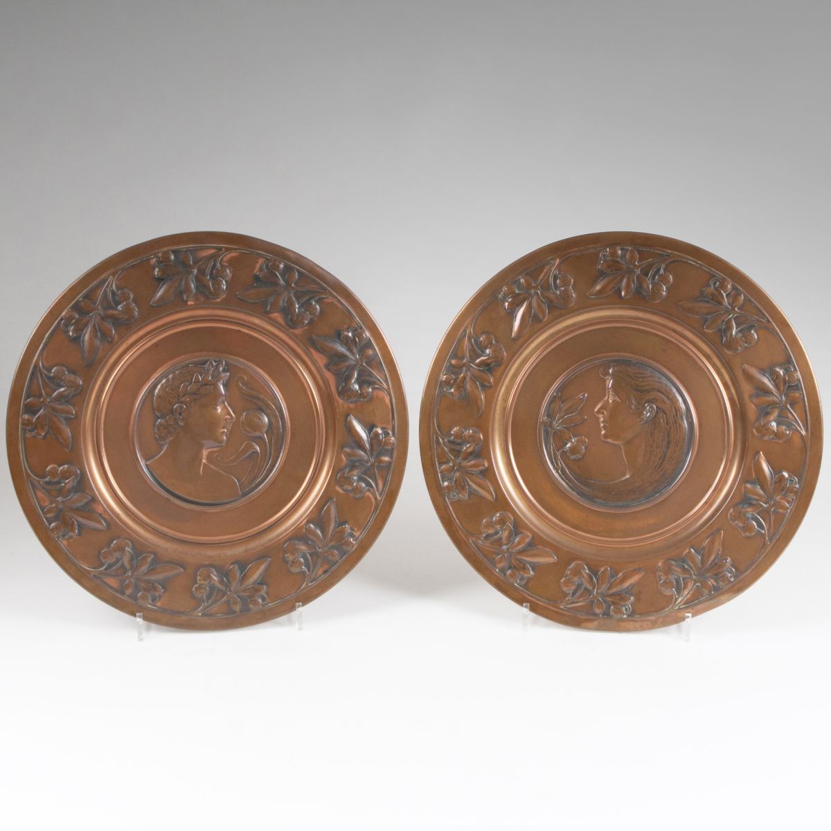A pair of decorative WMF-wall plates with the heads of a young man and woman in profile