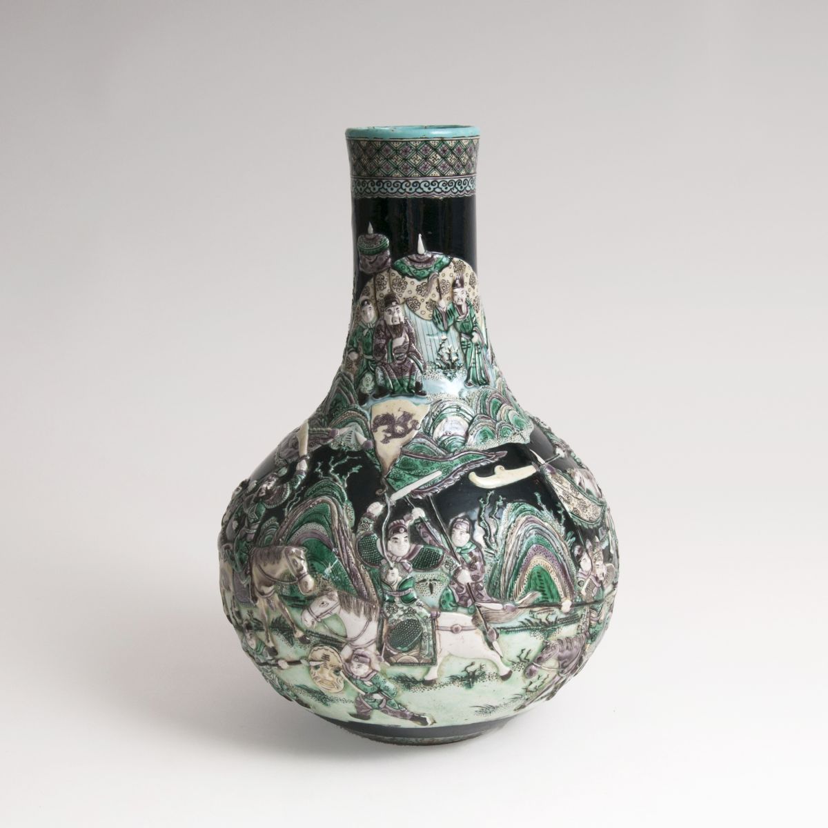 A 'Famille noire' baluster-shaped vase with relief decor