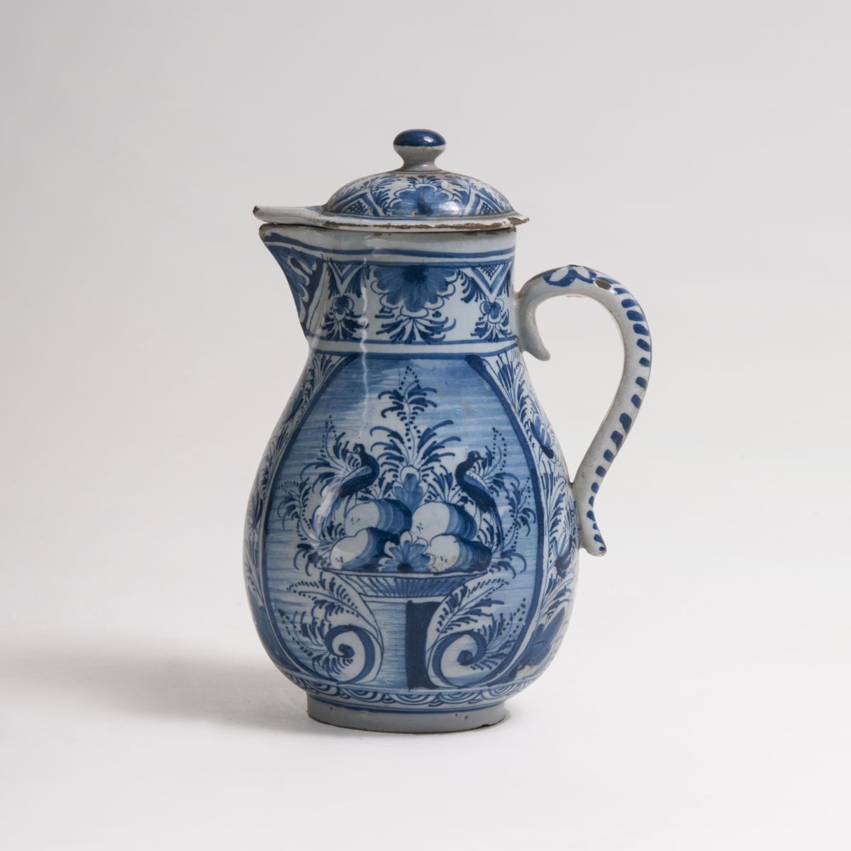 A small Faience pear-shaped Jug with blue painting