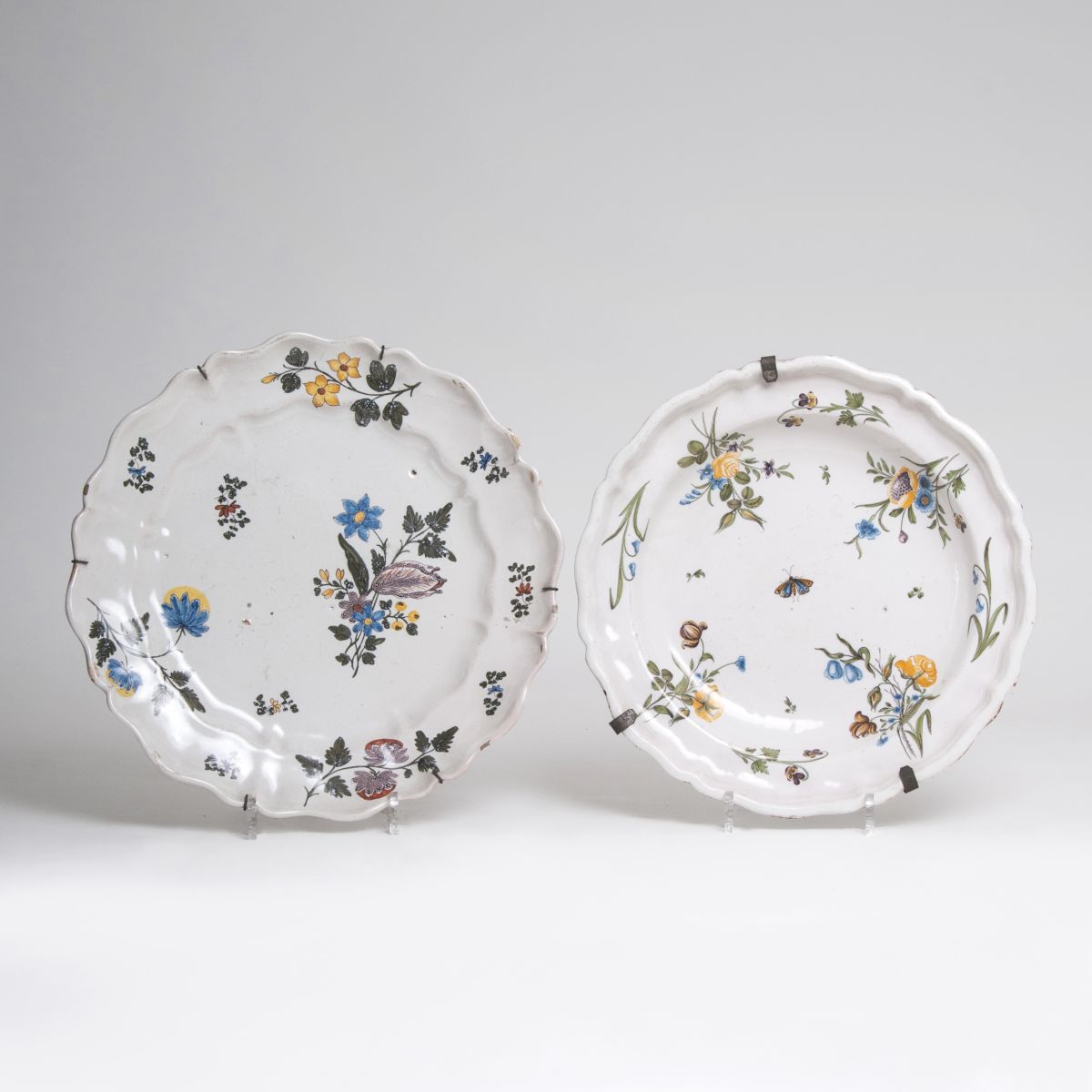 A pair of large faience platters with flower painting