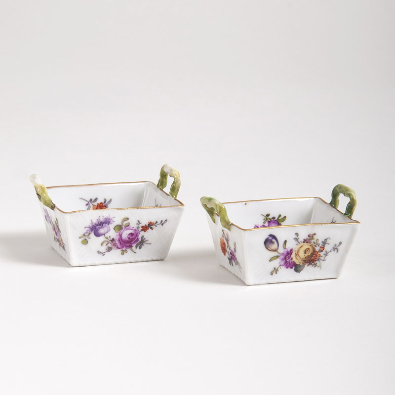 A pair of miniature baskets with flower bouquets