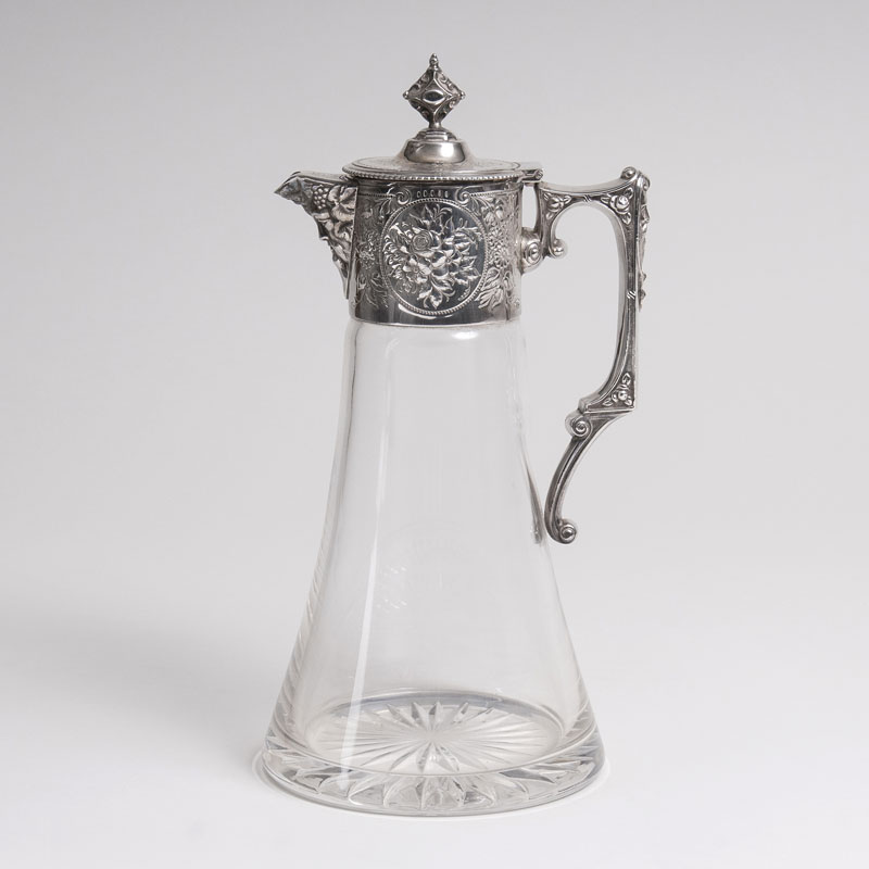 A wine crystal carafe with a floral silver mounting