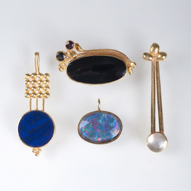 Four gold pendants with coloured stones