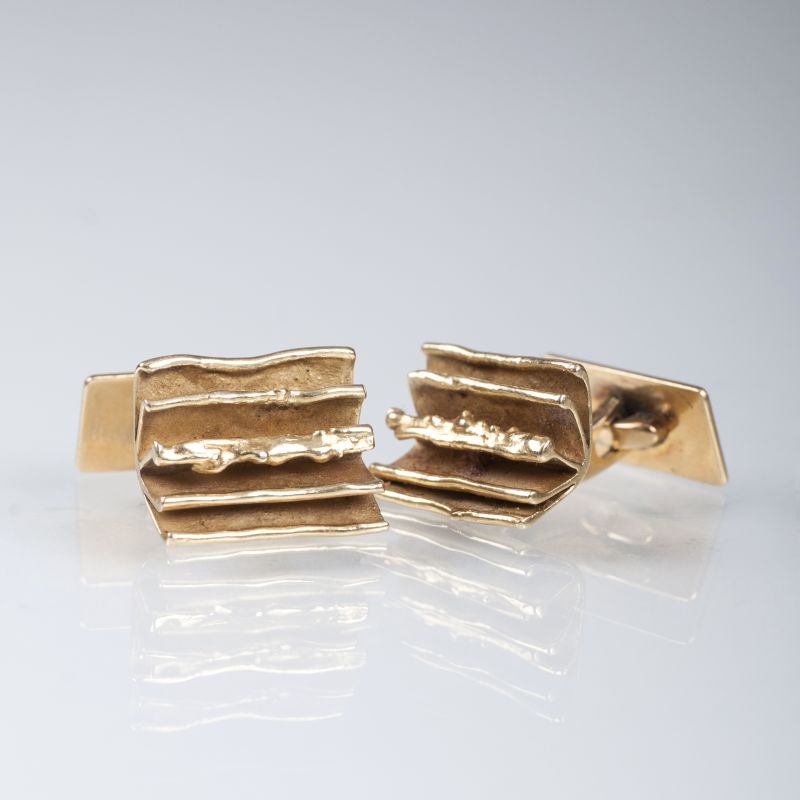 A pair of golden cufflinks