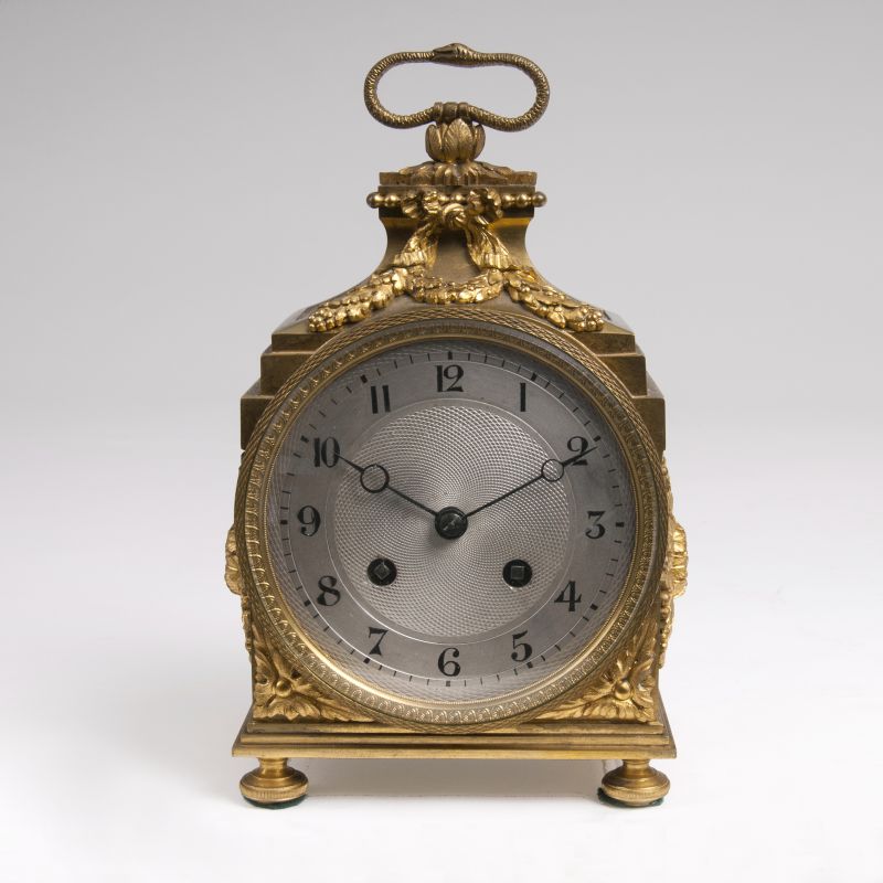A Louis Seize officer's carriage clock with ouroboros handle