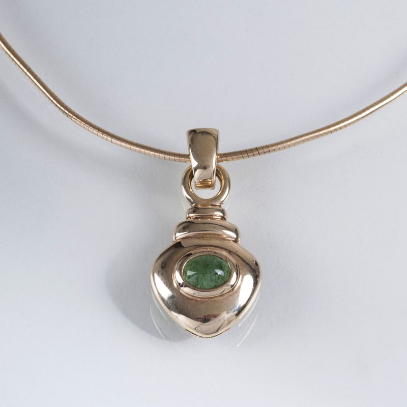 A heart shaped pendant with tourmaline on necklace
