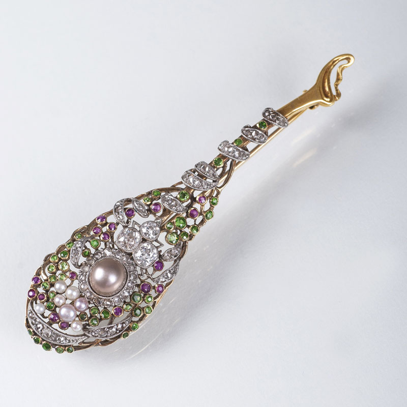 A Belle Epoque diamond pearl brooch with peridots and rubies