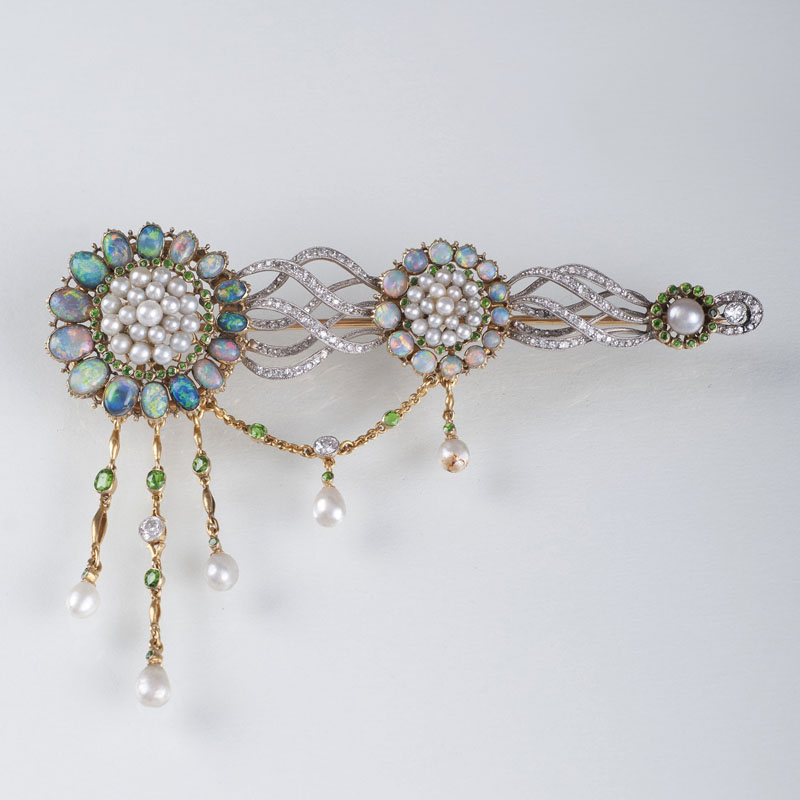 A Belle Epoque brooch with settings of opal, pearl, peridot and diamonds