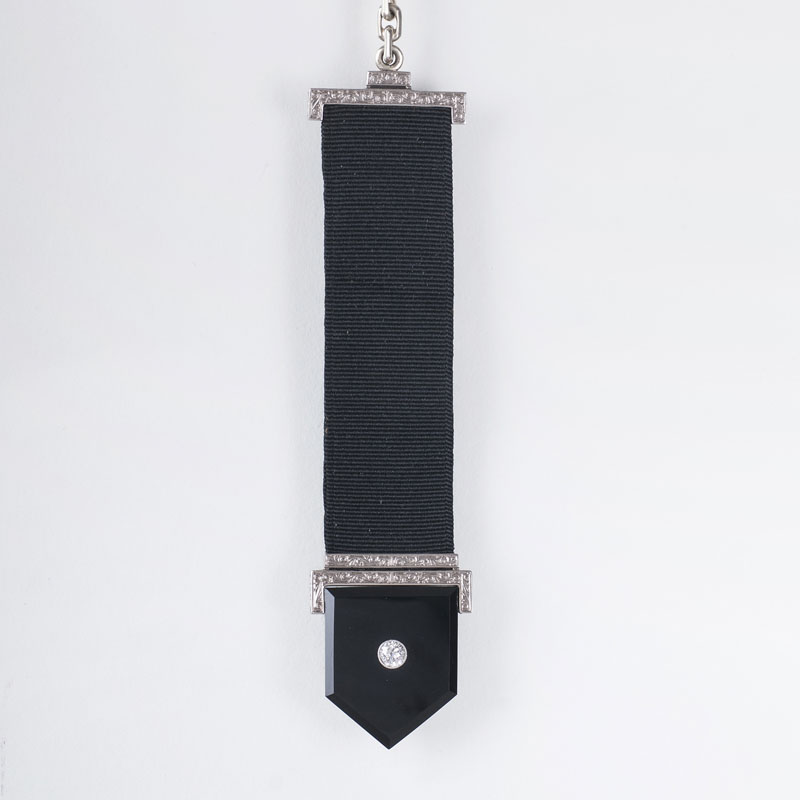 An Art-déco pocket watch chain pendant with onyx and old cut diamond