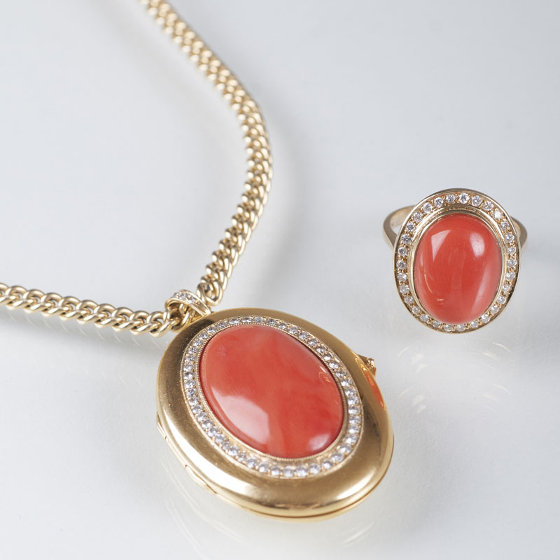 A coral diamond jewellery set with rind and amulets on necklace