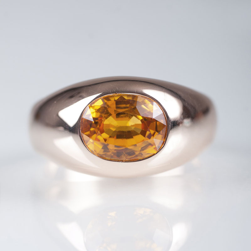 A gold ring with a yellow sapphire