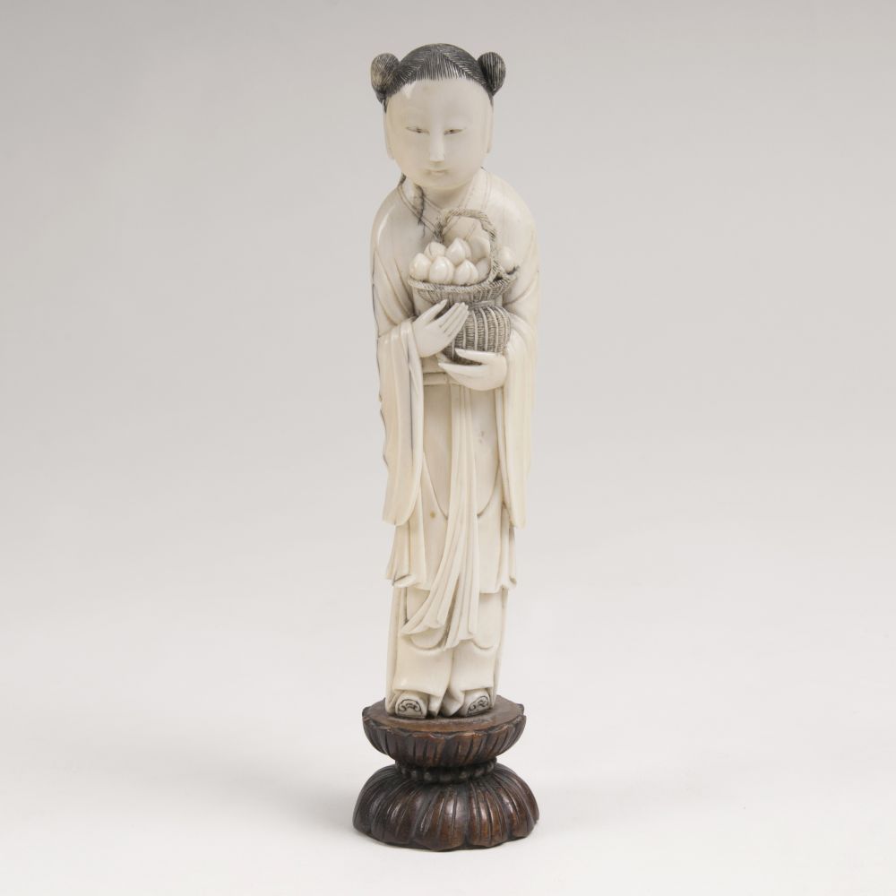 An Ivory Figure of a Boy with Peaches