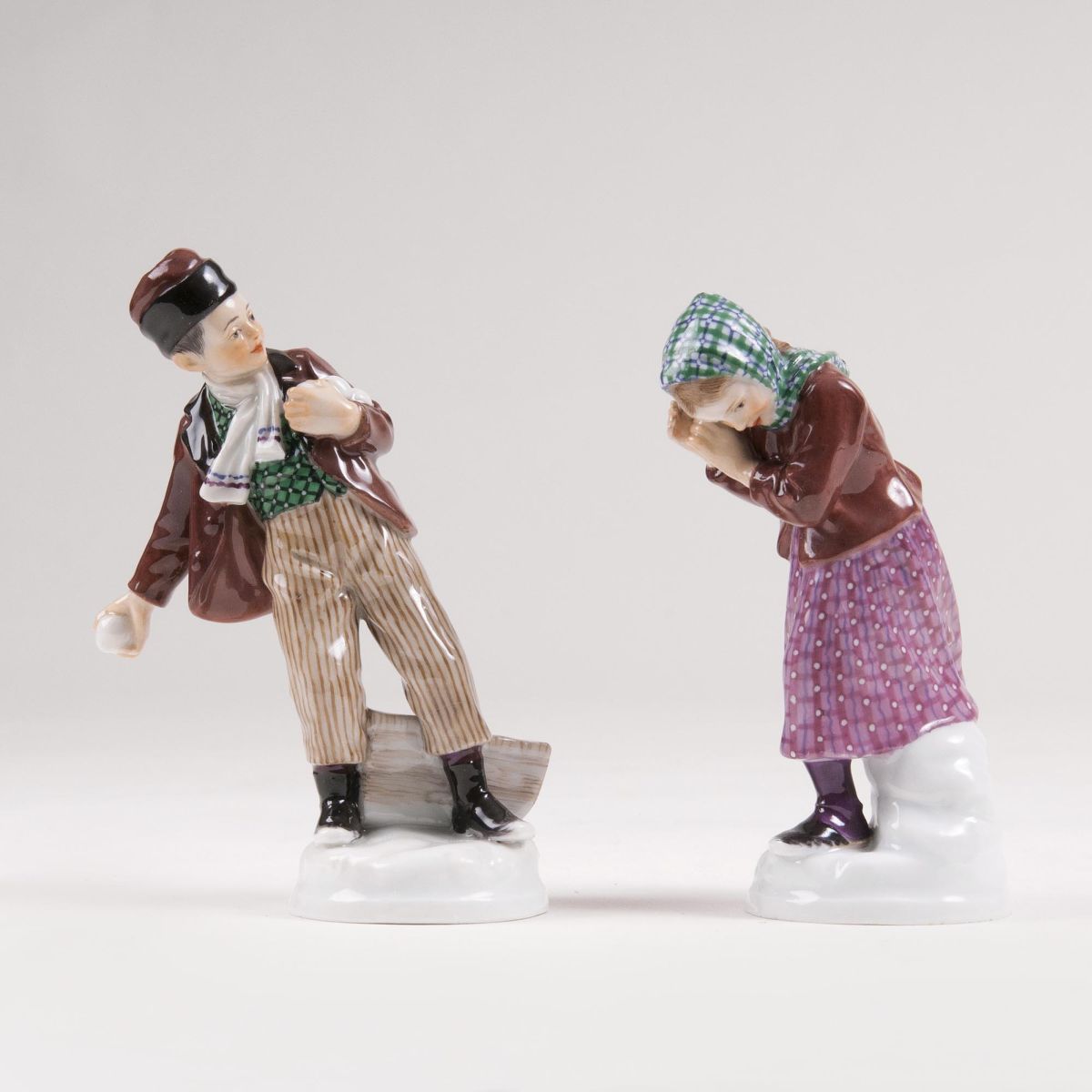 A Pair of Figures 'Boy throwing a snowball' and 'Girl fending off a snowball'
