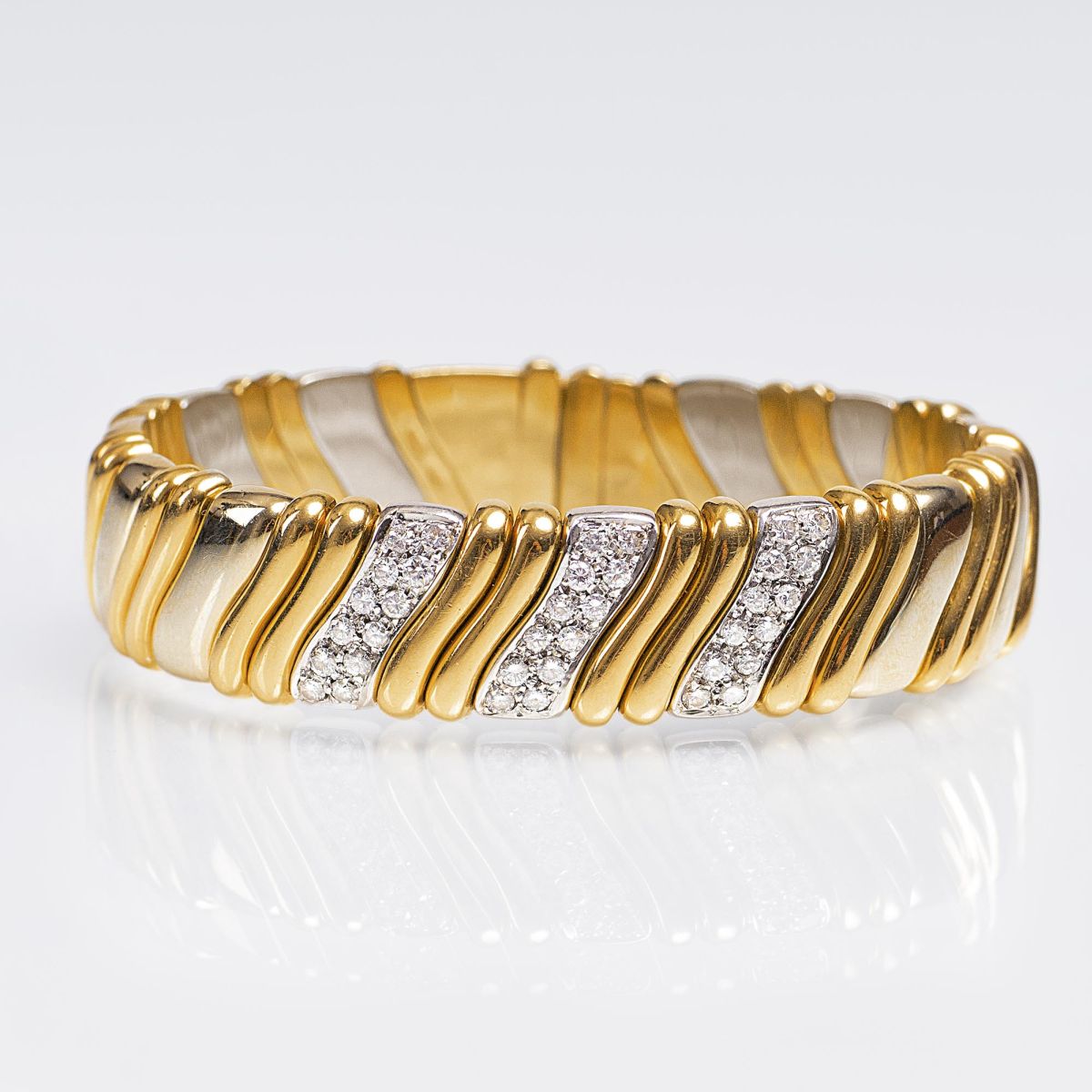 A Gold Bangle Bracelet with Diamonds A Gold Bangle Bracelet with Diamonds