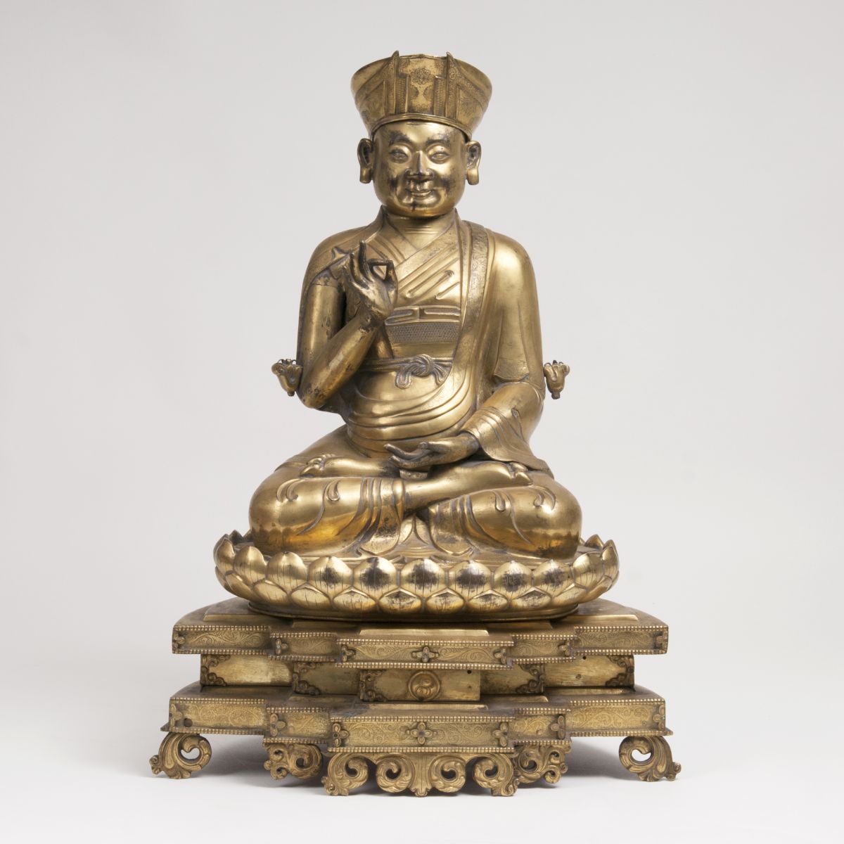 A Firegilded Repoussé Figure 'Sitting Lama', Tibetan 17th Century A Firegilded Repoussé Figure 'Sitting Lama', Tibetan 17th Century