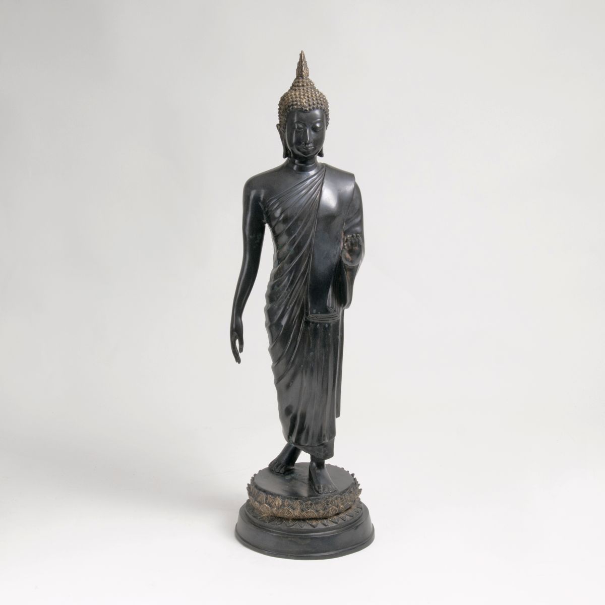 A Bronze Figure of Walking Buddha
