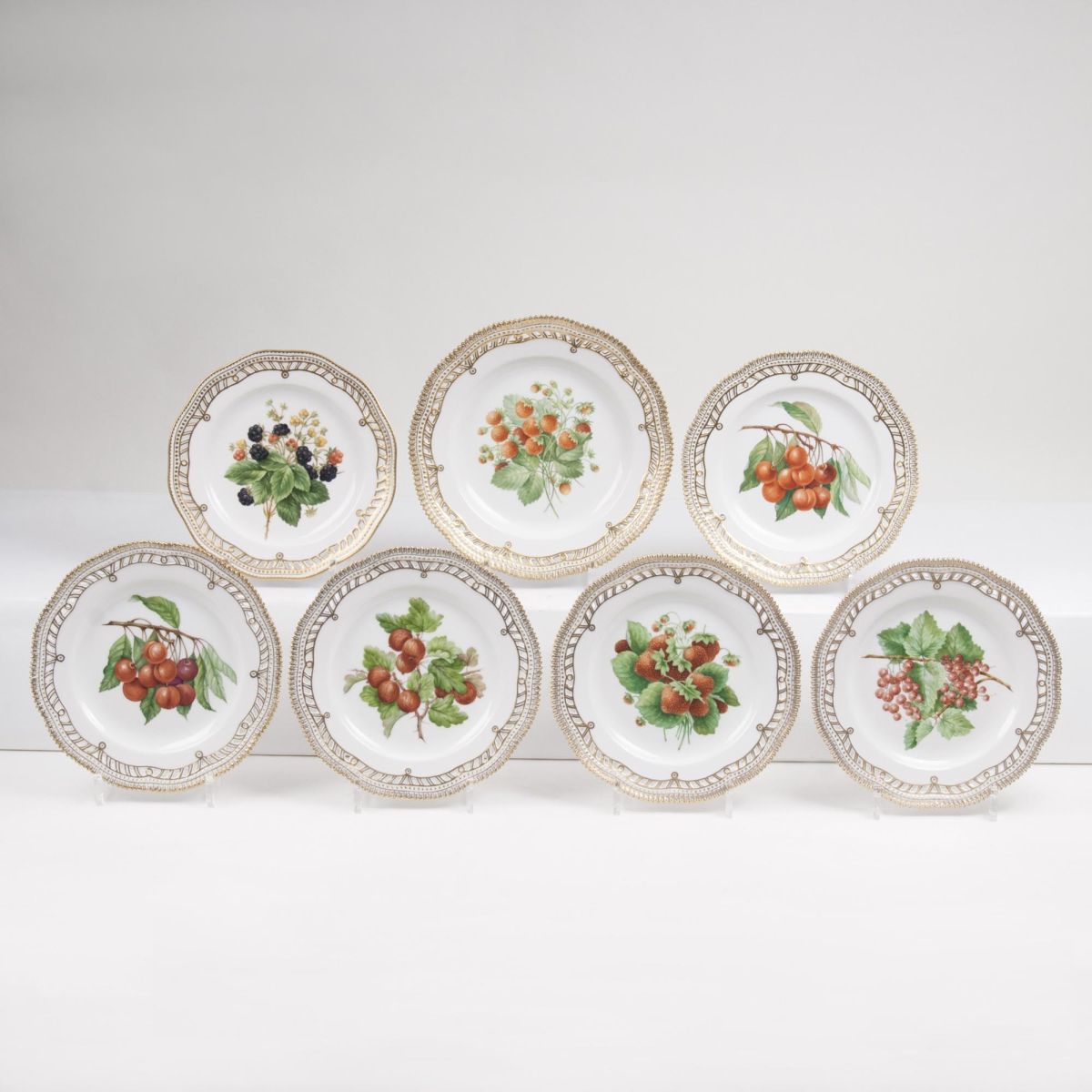 A Set of 7 Reticulated Plates with Fruits