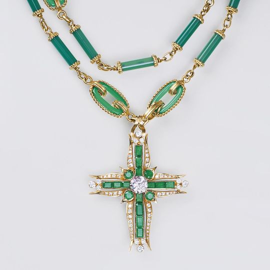 A highcarat Solitaire Diamond Pendant with Emeralds on long Necklace
