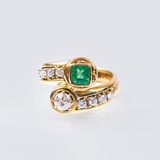 Cross-Over Ring mit Smaragd-Diamant Besatz