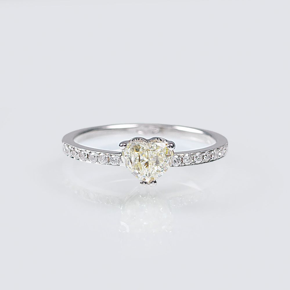 A Solitaire Ring with Heart shaped Diamond and small diamonds