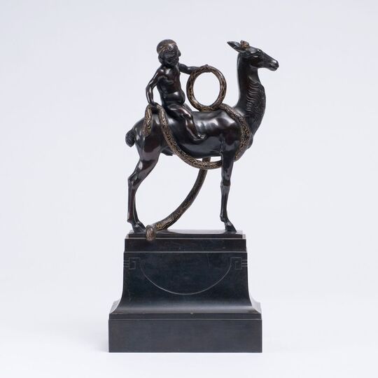 An Art Nouveau Bronze Figure 'Boy with garland, on deer'
