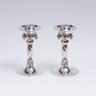 A Pair of Candleholders with Grabe Decor