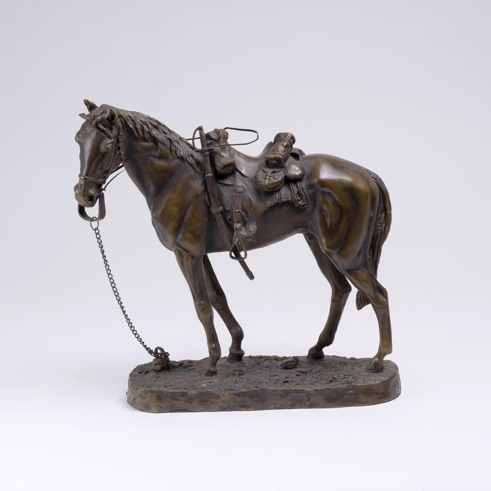 Figure of a standing chestnut colored horse, wearing a saddle and reins