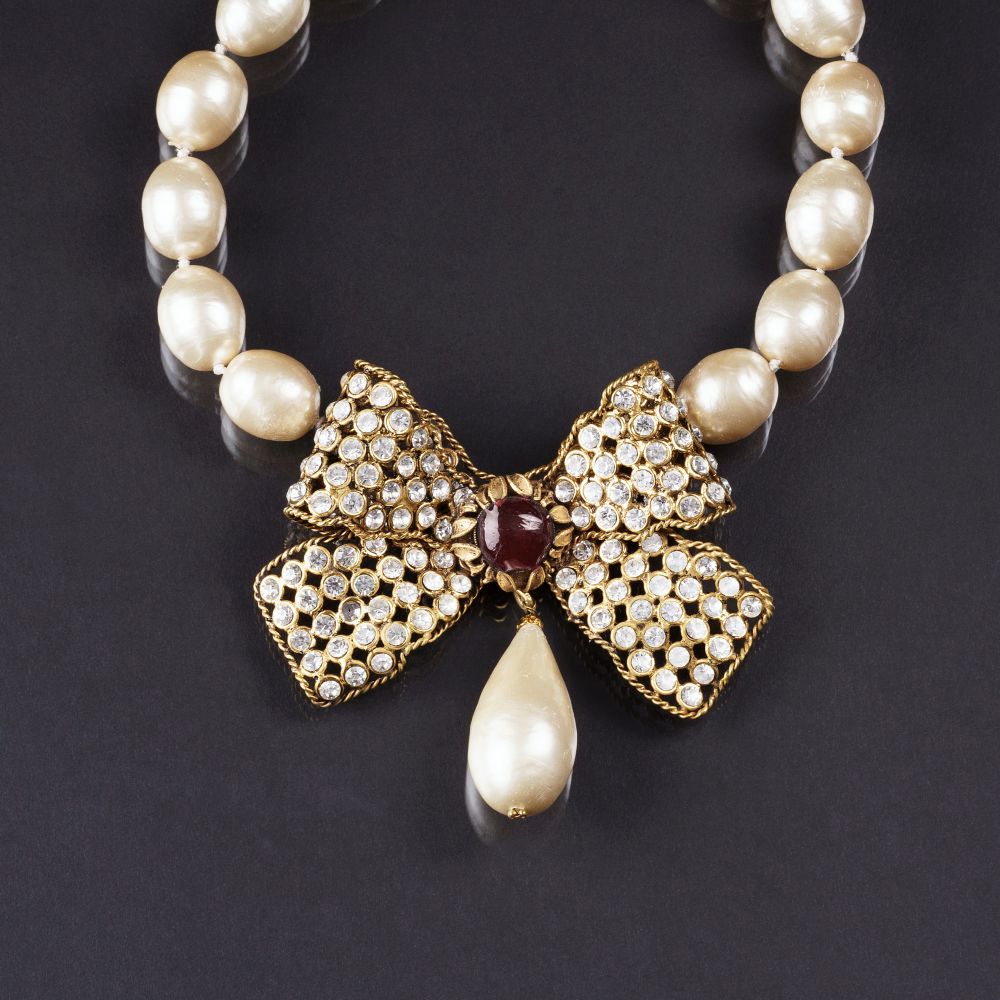 Chanel: A Faux Pearl Necklace with Large Crystal-Bow