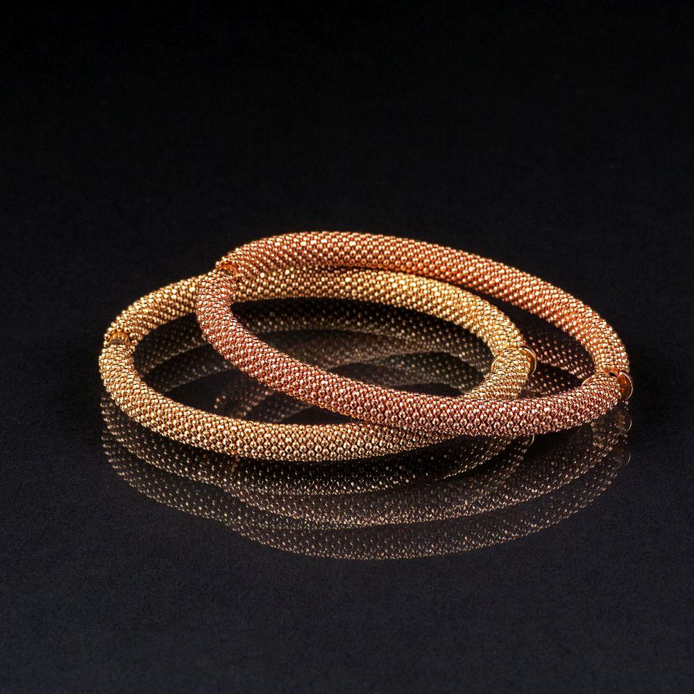 A Pair of bicolour Gold Bangle Bracelets