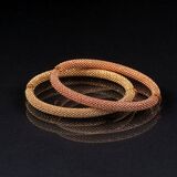 A Pair of bicolour Gold Bangle Bracelets - image 1