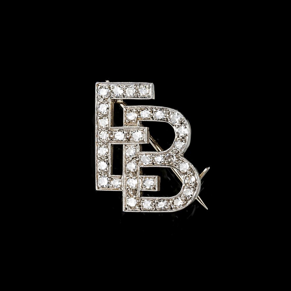 A small Monogram Diamond Brooch