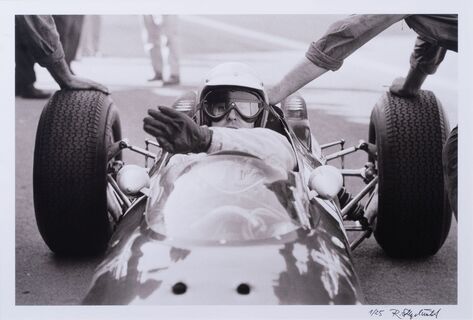 Bandini's Ferrari being pushed out of the pits