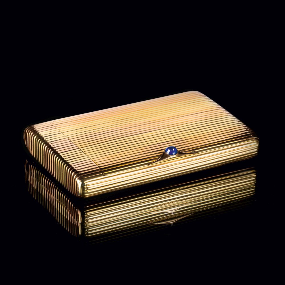 A Gold Etui with Sapphire Cabochon A Gold Etui with Sapphire Cabochon