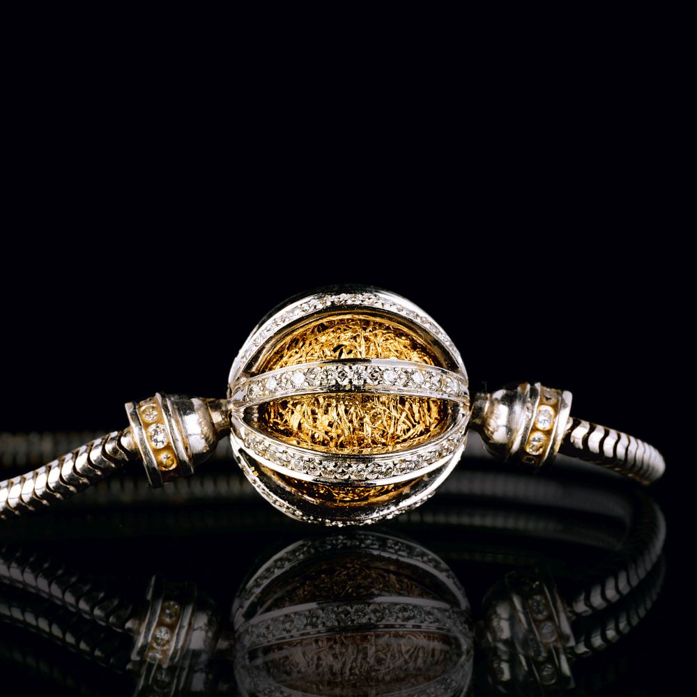 A two-coloured Gold Diamond Ball Pendant on Necklace