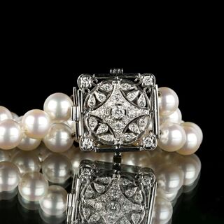 A long Pearl Necklace with Diamond Clasp
