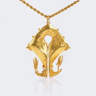 A Gold Pendant  on long Gold Necklace