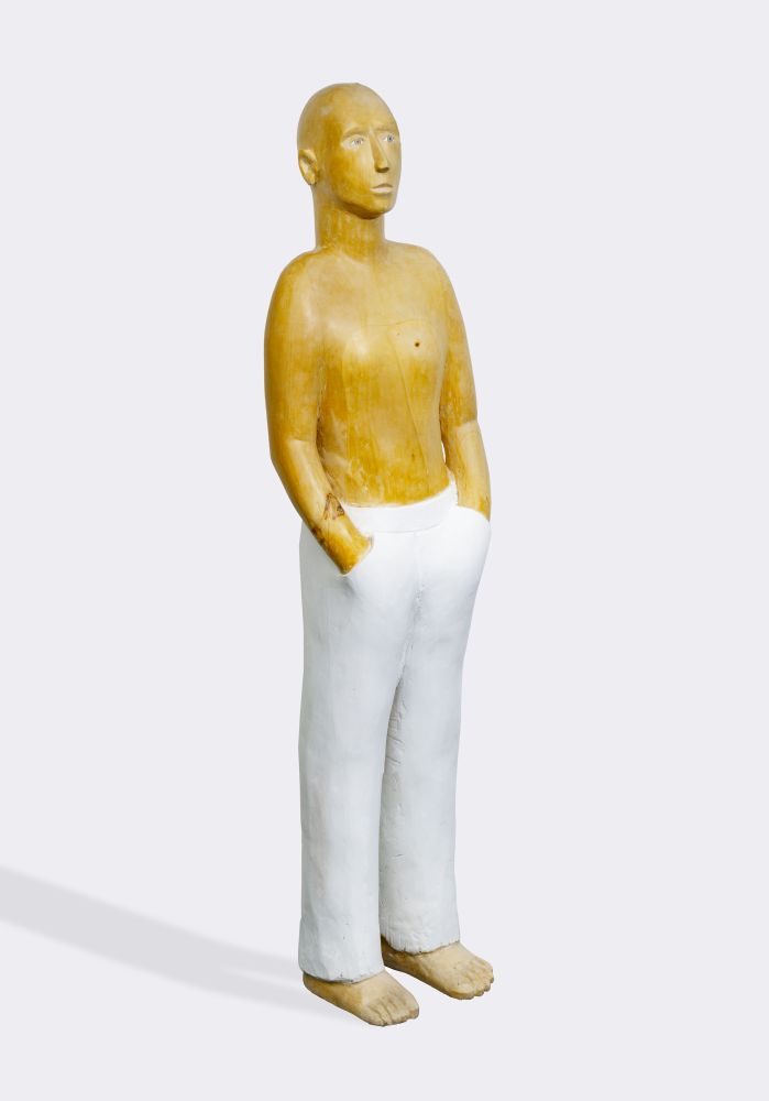 A Figure wearing white pants