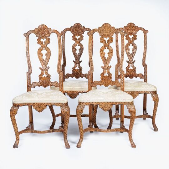 A Set of 4 Rococo Chairs with rare Scale Carving
