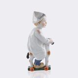 Kind mit Zeitungsmütze, auf einem Holzpferd reitend - Bild 2