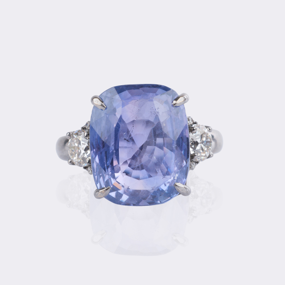 Natural color-changing Ceylon sapphire ring with diamond trim